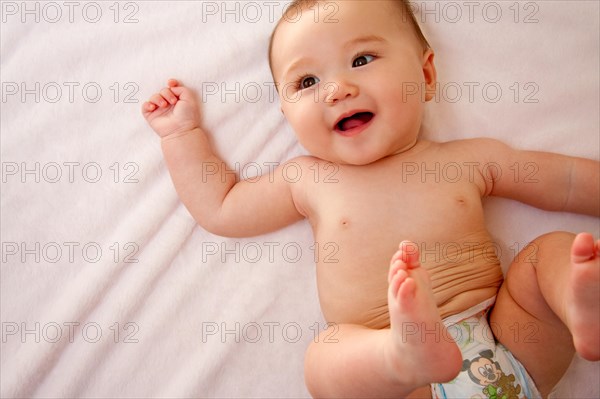 Smiling baby girl in diapers