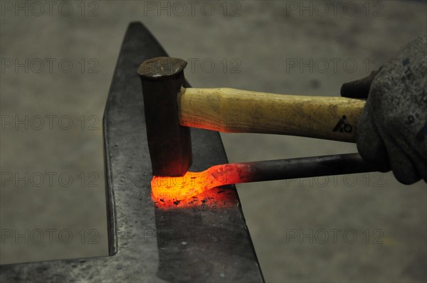 Forging iron on an anvil