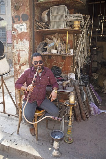 Egyptian man with sunglasses smoking a shisha or hookah