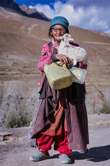 Elderly woman with at goat