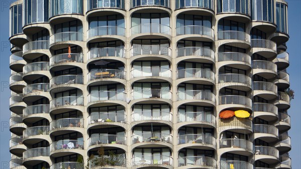 Two colourful parasols on the balcony of a high-rise building