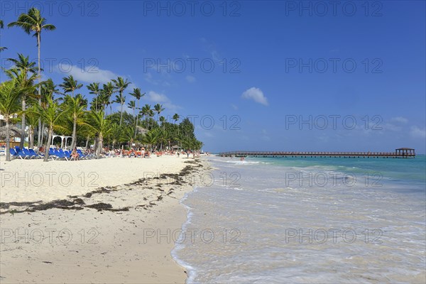 Dirty beach with jetty out to sea