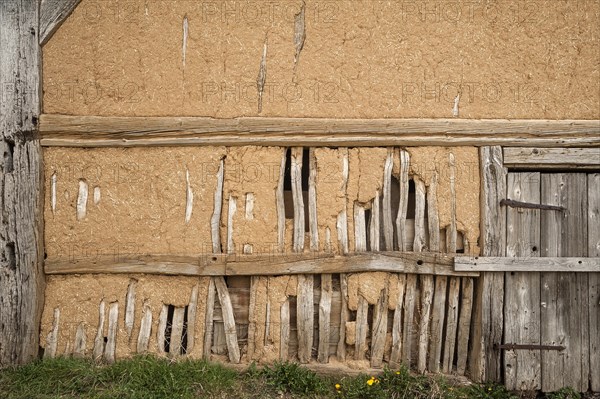 Exposed clay plaster wall of a barn