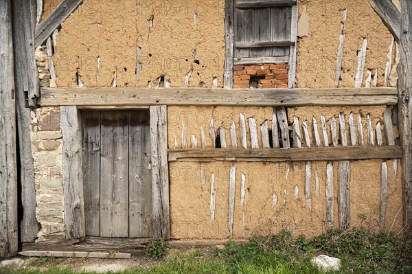 Exposed clay plaster wall of a barn