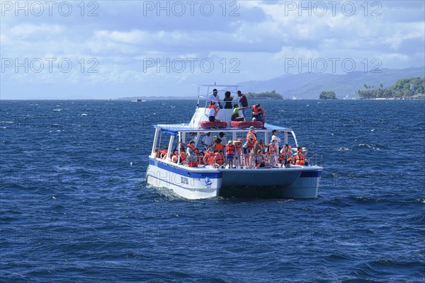 Tourists on a whale watching boat in Samana Bay