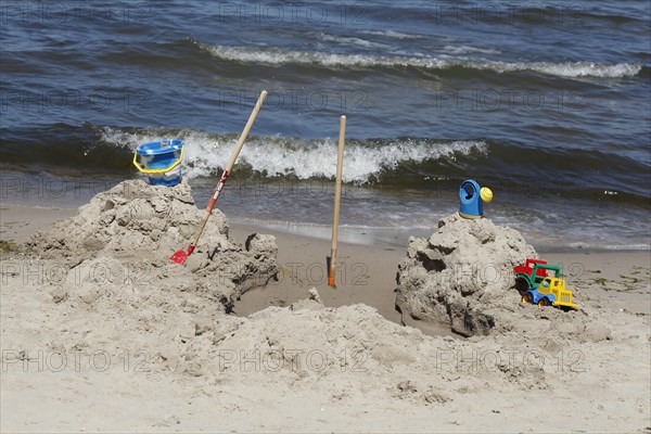 Toy and beach castle on a sandy beach by the sea