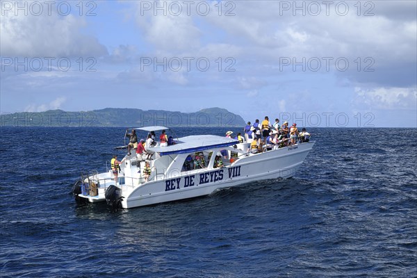 Tourists on a whale watching boat in Samana Bay