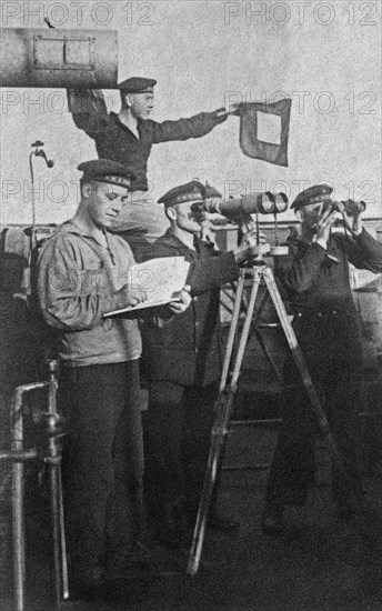 Sailors posing for a photo on their ship