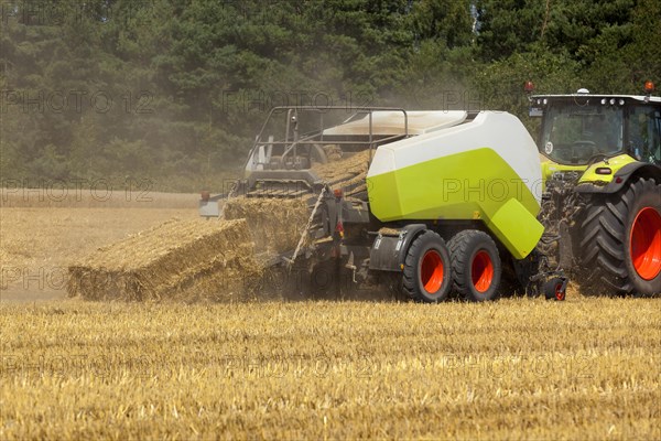 Tractor with a straw baler