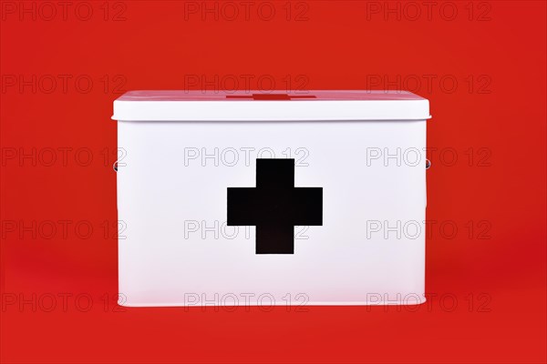 White first aid kit with black cross on red background