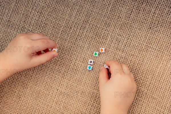 Little cubes with heart shape in hand on canvas