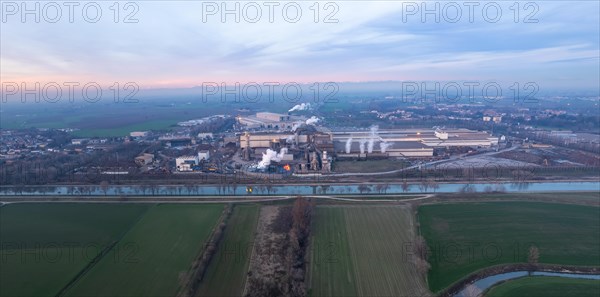 Drone aerial view of working steel plant at dawn