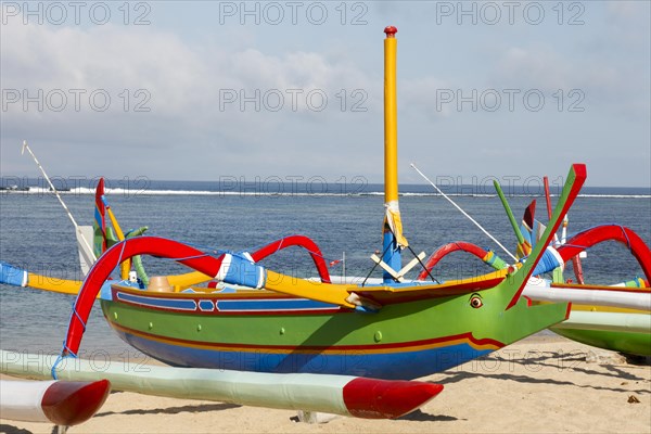 Brightly painted fishing outriggers on the beach at Sanur