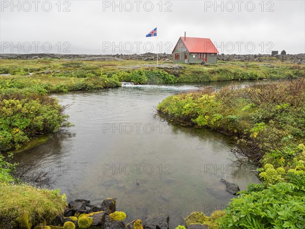 Icelandic flag in front of hut in the highlands of Iceland