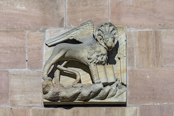 Historical house sign with the lion of St Mark on a residential and commercial building