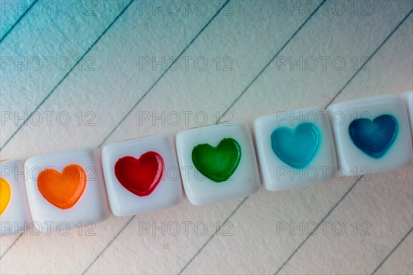 Colorful cubes with a heart placed on paper