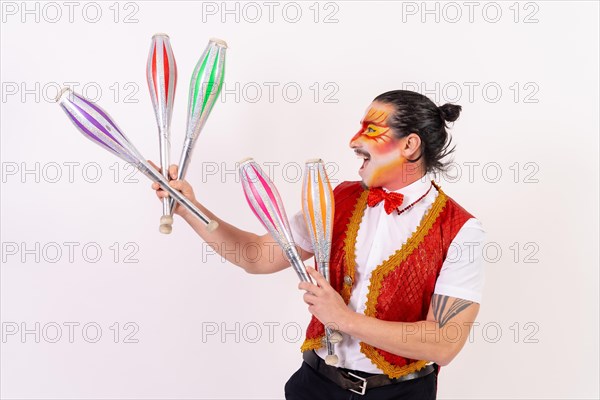 A smiling mime juggling isolated on white background