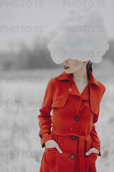 Woman in red coat with cloud on her head in the snow