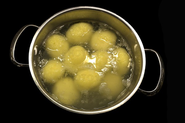 Potato dumplings in a pot of boiling water