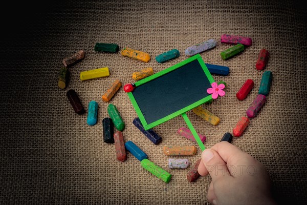 Notice board in the middle of crayons form a heart shape