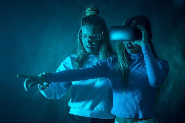 Two futuristic women in vr glasses