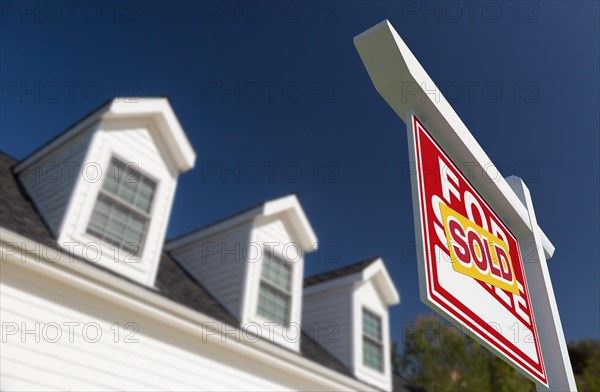 Sold for sale real estate sign in front of new house