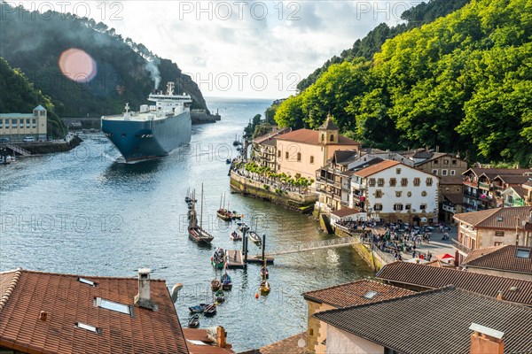 Entrance of a giant merchandise ship in the bay of Pasaia to the open sea Pasajes