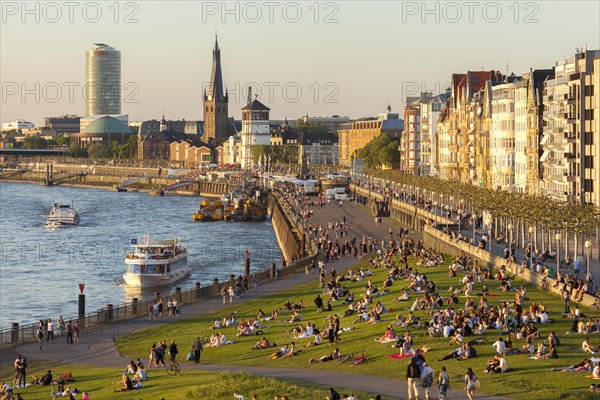 Outdoor sunny view of crowd of people sit