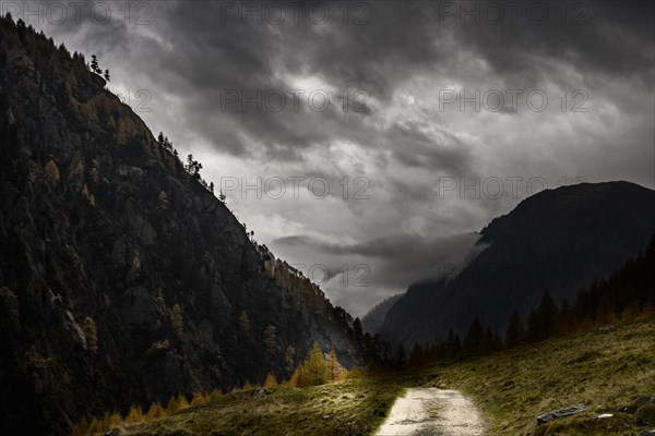 Autumnal mountain landscape with threatening cloudy sky