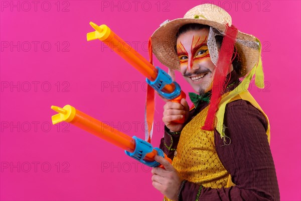 Clown with white facial makeup on a pink background