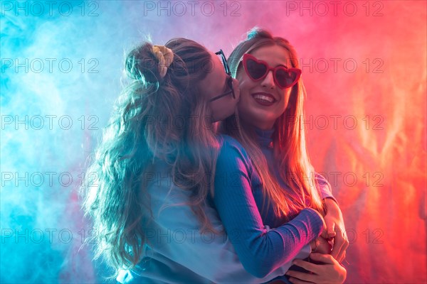 Two young blonde caucasian women dancing in disco