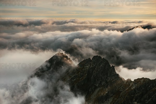 The rising sun illuminates the mountainous landscape