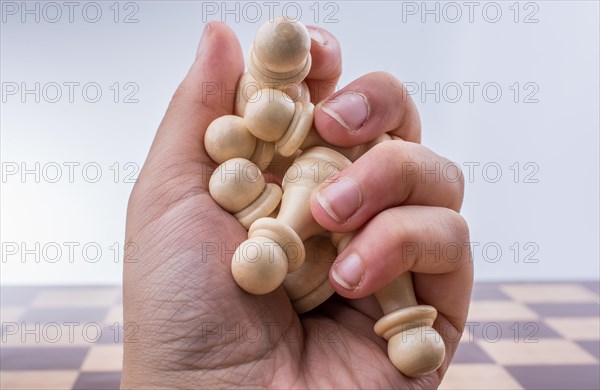 Chess board with chess pieces in the hand