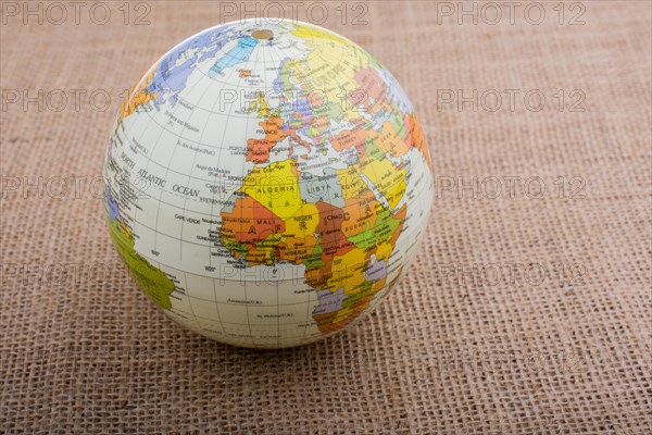 Globe placed on a brown fabric background