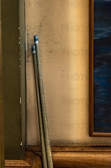 Two billiard cue sticks on the wall