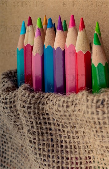 Color Pencils in a linen sack on canvas