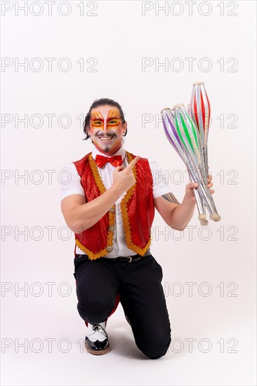 Portrait of a smiling juggler juggling isolated on white background