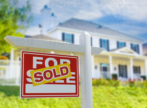 Sold for sale real estate sign in front of new house