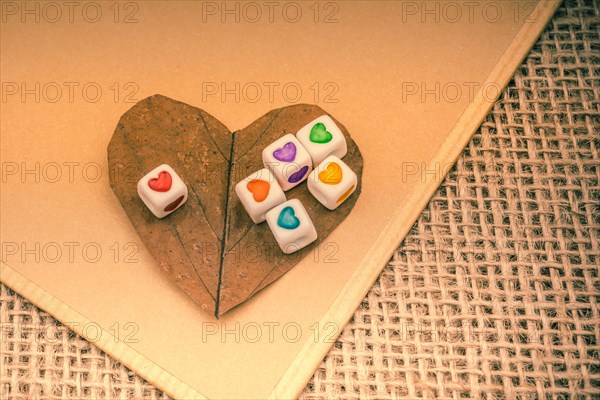 Colorful cubes with a heart on notebook on canvas