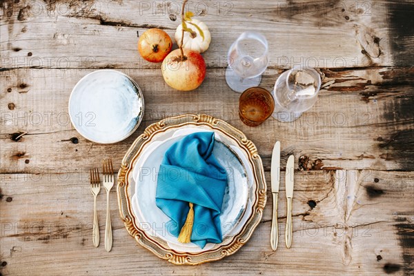 Golden and blue elegant table set on wooden background