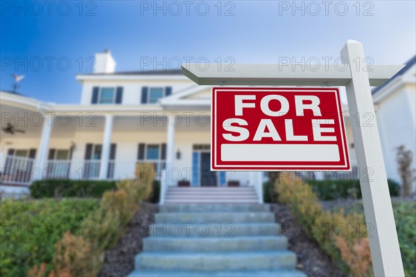 For sale real estate sign in front of new house