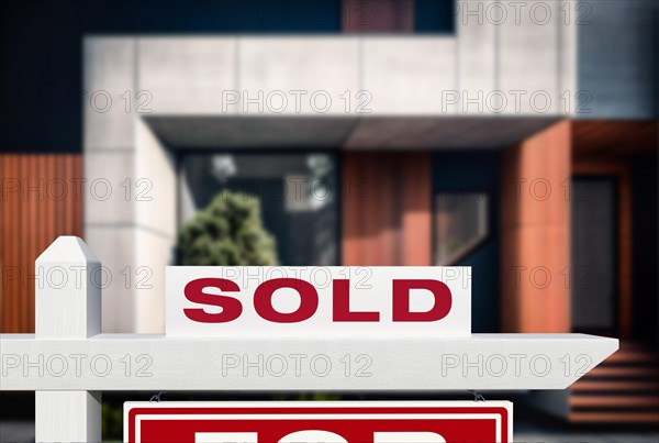 Sold real estate sign in front of new contemporary house