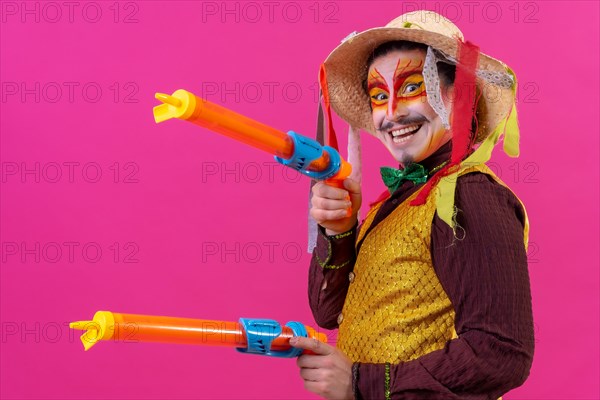 Clown with white facial makeup on a pink background