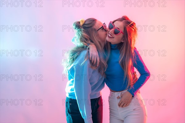 Two young blonde caucasian women dancing in disco