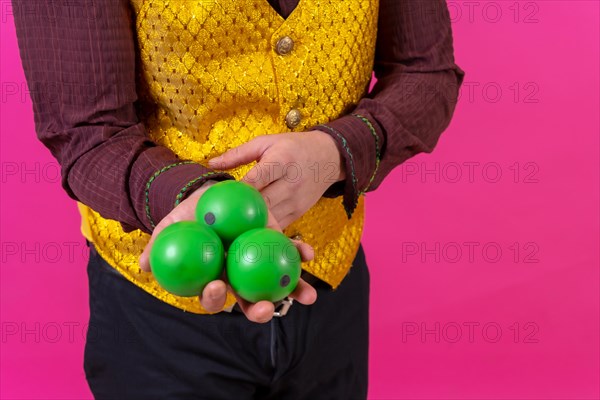 Portrait of clown with white facial makeup on a pink background