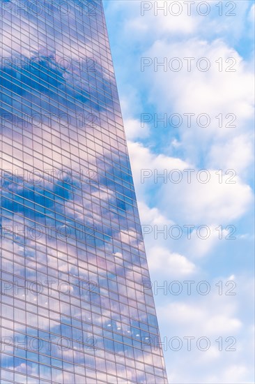 Reflection of clouds in a glass building