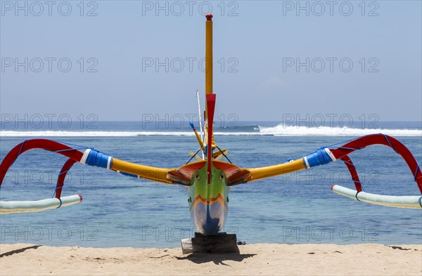 Brightly painted fishing outriggers on the beach at Sanur