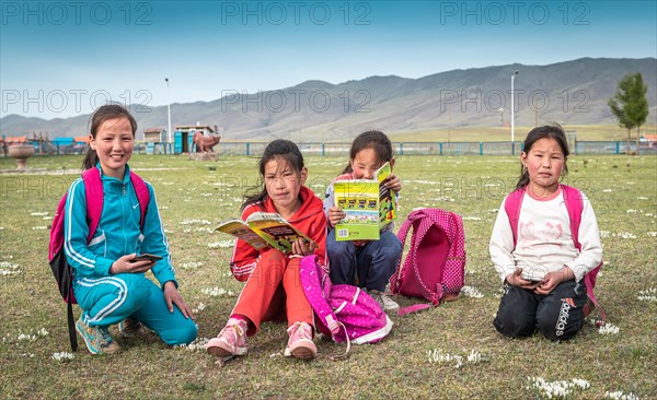 Schoolgirls reading books in their free time. Bulgan frovince