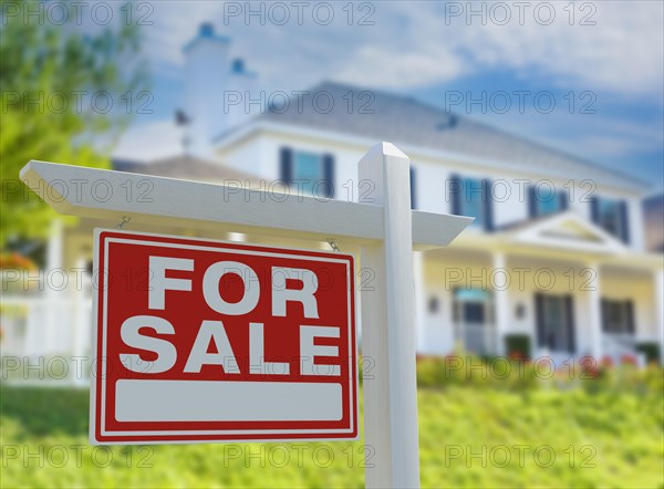 For sale real estate sign in front of new house