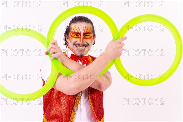 Portrait of a juggler smiling with juggling hoops isolated on white background